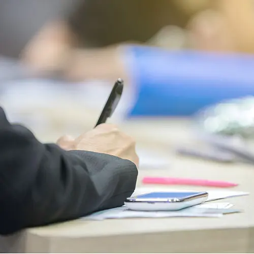 A person is writing on a piece of paper.