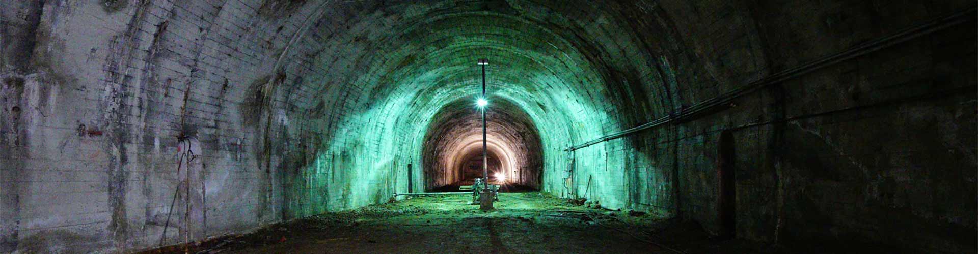 A tunnel with a green light in the middle.