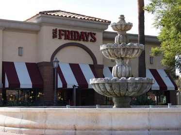 A fountain in front of a restaurant.